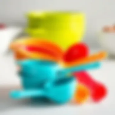 A set of measuring cups and spoons in bright colors arranged neatly