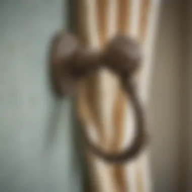 Close-up of a beautifully designed antique curtain hook highlighting its craftsmanship.